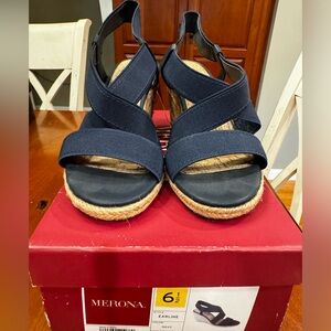 Brand new! Never worn! These sandals are navy blue with elastic straps.